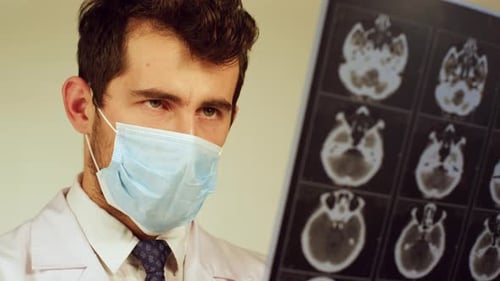 Doctor Analyzing Brain CT Scans
