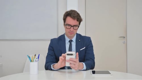 Professional Adult in Suit Using Mobile Phone
