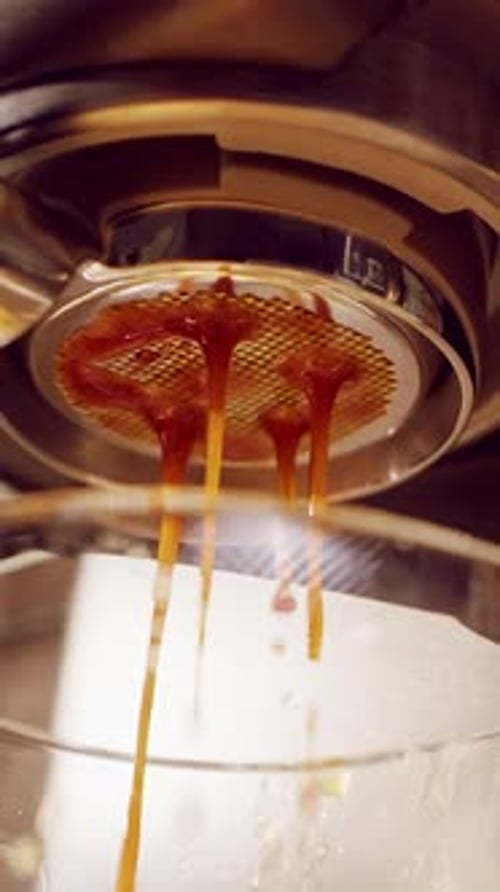 Vertical video. Slow Motion Extreme Close Up Of Espresso Pour Exploding From Bottomless Portafilter