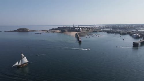 Sailboats Sailing Near Old Coastal City Aerial View