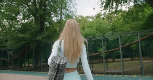 Attractive Sporty Girl in Blue Sportswear with Bag Went in Park for Training