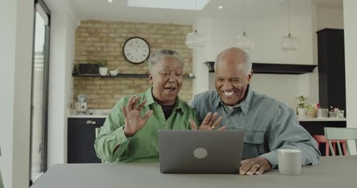 Senior Couple Video Calling With Laptop in Home