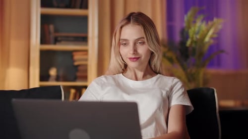 Captured in This Stock Footage is a Moment of a Young Woman Engaged with a Laptop While at Home
