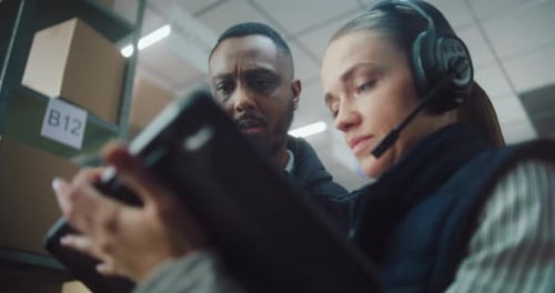 Female Logistics Manager Uses Tablet Computer in Warehouse Facility African American Supervisor