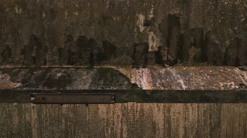 Cinematic aerial drone footage gliding through an abandoned factory interior
