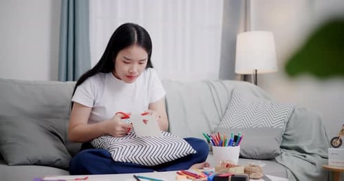 Creative Woman Crafting at Home on the Couch