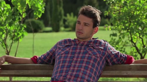 Young Man Relaxing on Park Bench