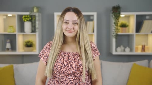 Blonde Woman Smiling and Gesturing Indoors