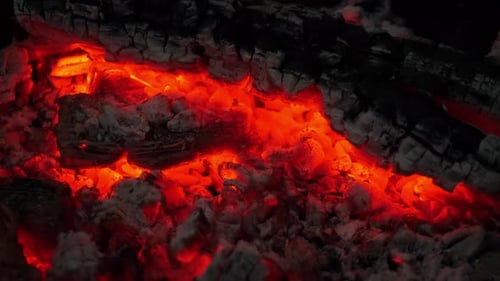 Intimate View of Smoldering Embers Emitting a Gentle Radiant Orange Glow