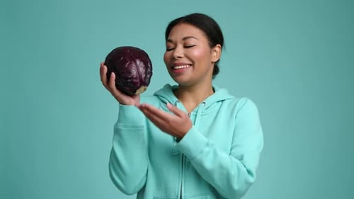 Portrait of Brunettehaired Young Woman Holding Raw Purple Cabbage