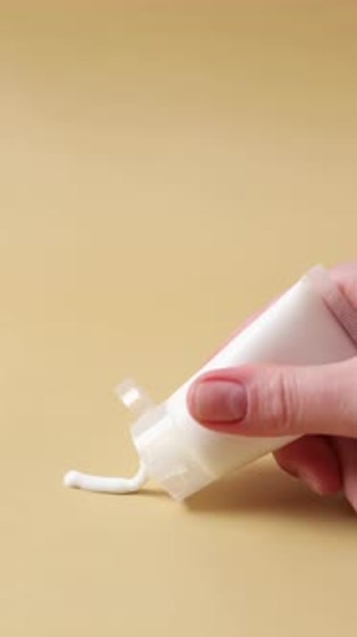 Woman Hand Spreading Cosmetic Cream on Surface Skincare Texture Demonstration with Lotion Smear