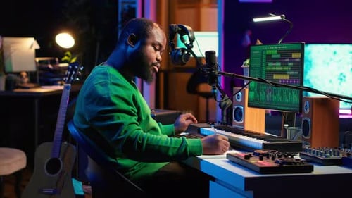 Songwriter Taking Notes to Create New Tracks for an Album in His Home Studio