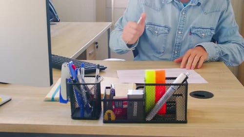 Employee Signs Documents in Office