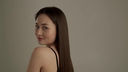 Woman with Long Straight Brown Hair Posing