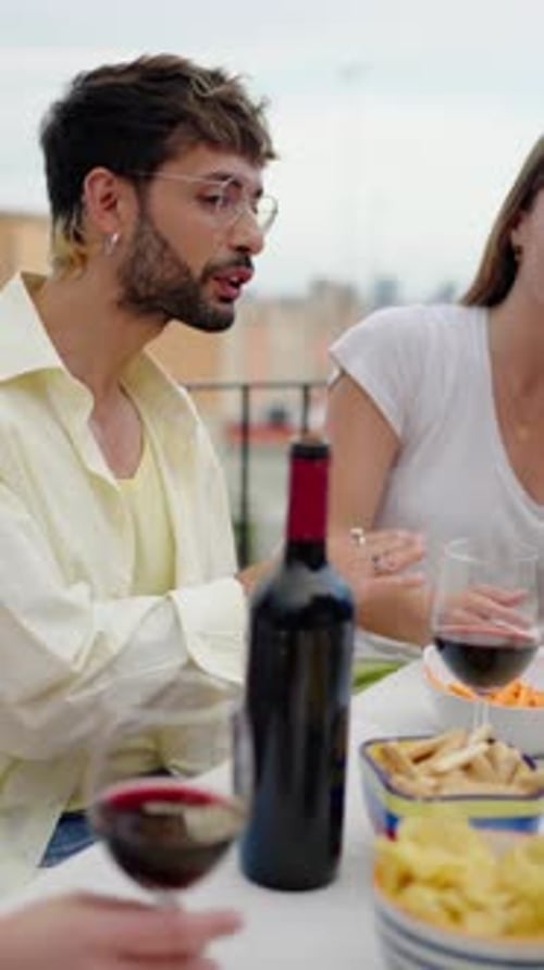 Friends Enjoying Wine and Conversation on Rooftop