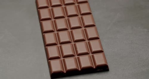 CloseUp of Solid Chocolate Bar on Dark Background in Simple Design
