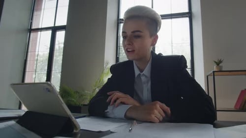 Young Woman Attending Virtual Meeting in Modern Office
