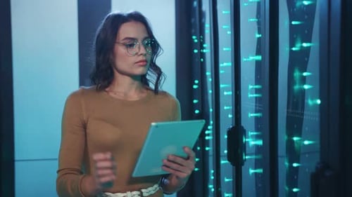 Woman Uses Tablet in Blue Lit Server Room