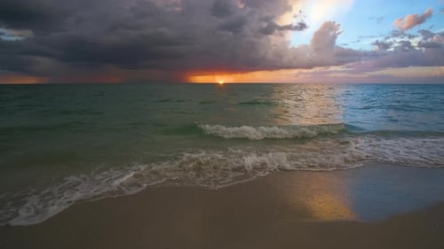Sunset Landscape of Rainstorm with Lightning and Thunder Over Sea Water Waves Crushing on Sandy