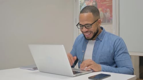 Young Adult Having Video Call on Laptop