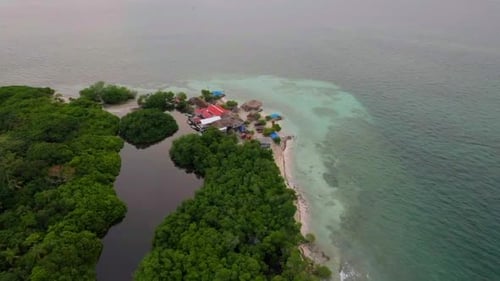 Exotic coastal eco hotel in private beach on tropical Caribbean island. Aerial