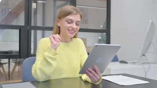 Woman Video Calling on Tablet in Modern Workplace