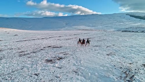 Horseback Riding Through a Snowy Mountain Landscape