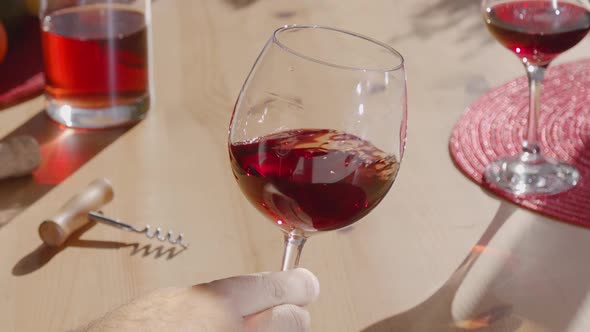 Decanting red wine in the glass by swirling it, giving more flavor ...