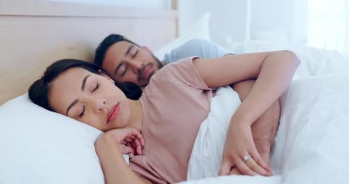 Happy Couple Sleeping Peacefully in Bed Together