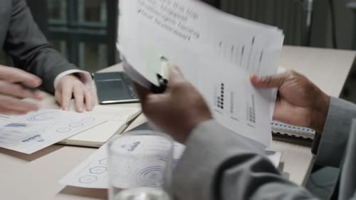 Business People Reviewing Charts in Office