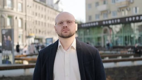 Serious Man Standing in Urban Environment