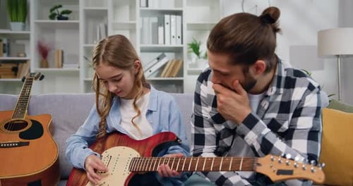 Girl Plays Guitar for Cheering Dad at Home