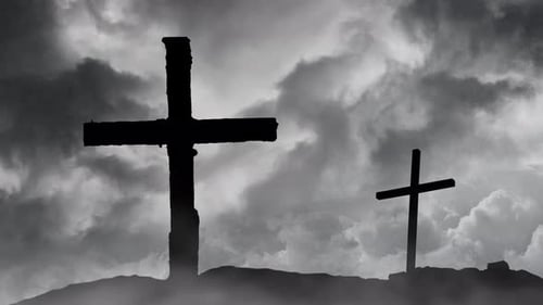 two graves on a silhouetted mountain.