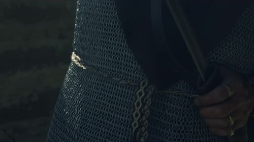 Man in Medieval Armor with Sword Preparing for Battle