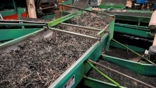 Shredded Rubber on Conveyor Belts in Factory