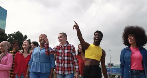 Multiracial group laughing together in a park celebrates diversity and friendship