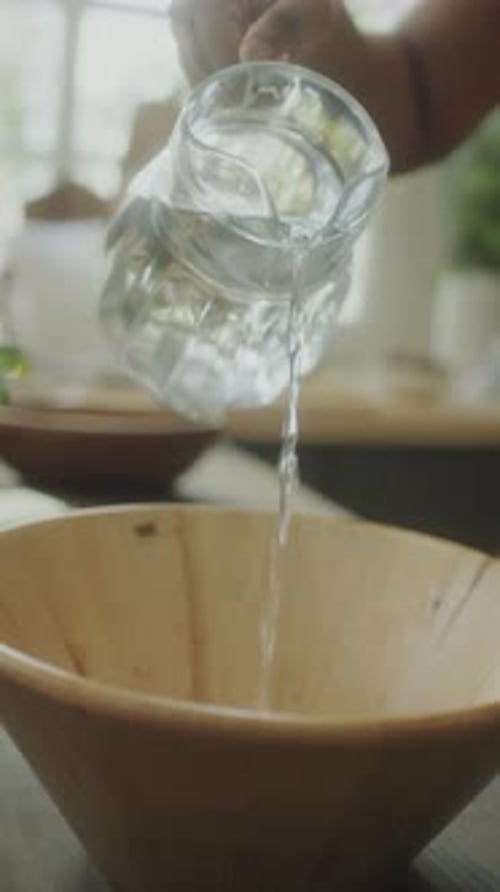 Pouring Water into Wooden Bowl