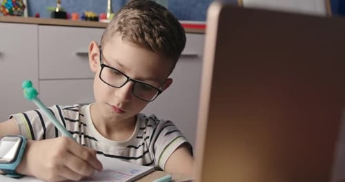 Boy Studying Online, Raising Hand to Participate