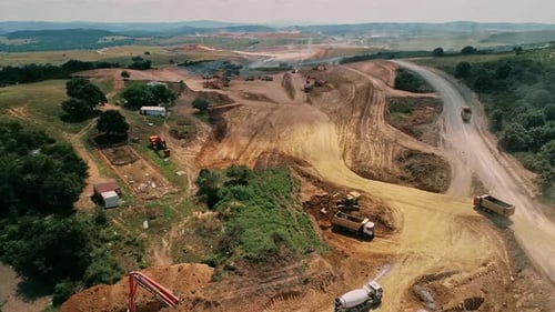 Construction Vehicles Building Road in Rural Environment