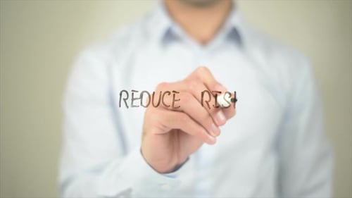 Reduce Risk, Man Writing on Transparent Screen