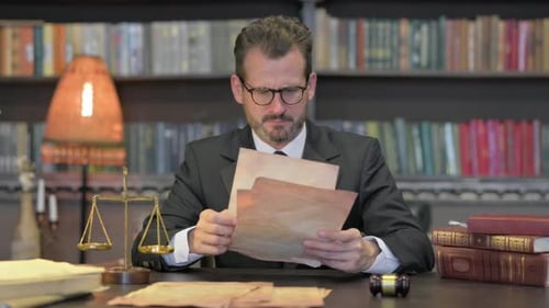 Tense Middle Aged Lawyer Shocked while Reading Court Orders in Office