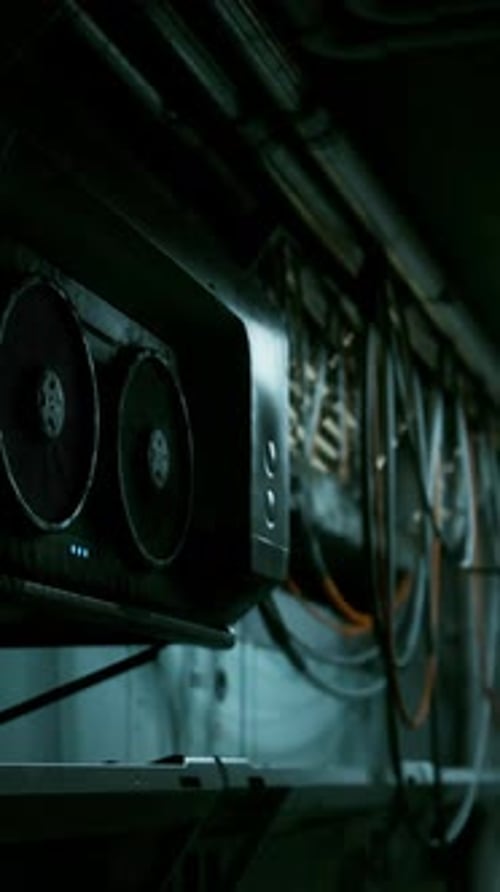 A Computer on a Dark Concrete Wall in a Dimly Lit Room