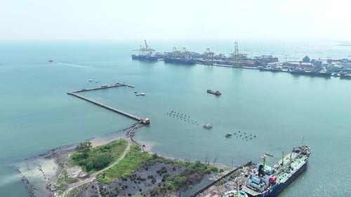 Aerial View Of Tranquil Coastal Port with Ships and Cranes