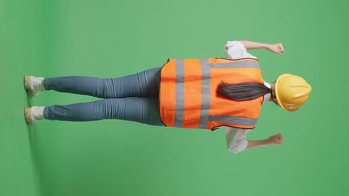 Full Body Back View Of A Female Engineer Raising Her Hands Celebrating In The Green Screen