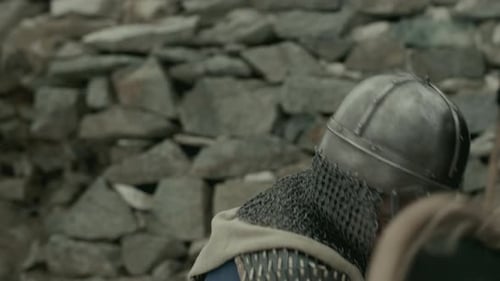 Man in Medieval Armor Running with Shield