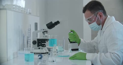 Scientist Using Pipette in Modern Laboratory