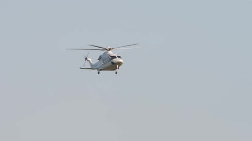 Helicopter Ascends Gracefully Through a Clear Sky