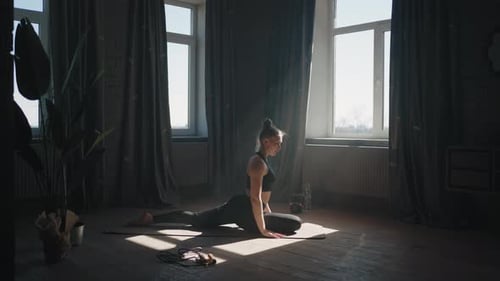 Woman Stretching on Yoga Mat in Sunlight