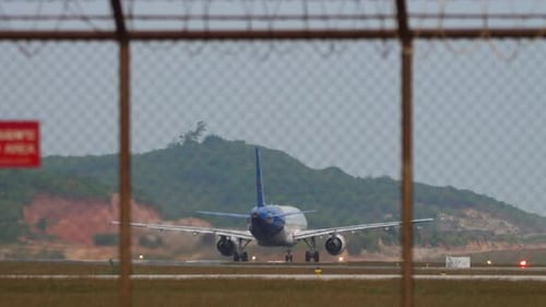 View Through the Airport Fence Plane Taking Off