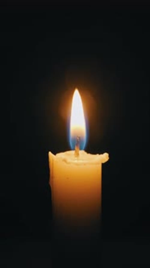 Candle is Lit with Match Flame in Darkness